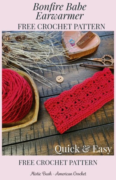 Red crochet earwarmer displayed on a wooden surface with matching yarn, crochet hooks, scissors, a ‘Handmade with Love’ button, and rustic pinecone accents, alongside text promoting the Bonfire Babe Earwarmer free crochet pattern.