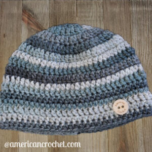 A blue-grey striped crochet beanie hat on a wood background.
RDH Marble Beanie | American Crochet @americancrochet.com