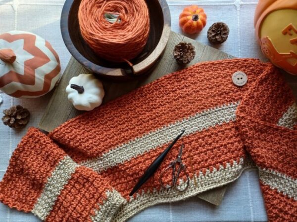 Buttercup Spice Crochet Blanket in cozy orange and cream fall colors, featuring a textured crochet pattern | American Crochet