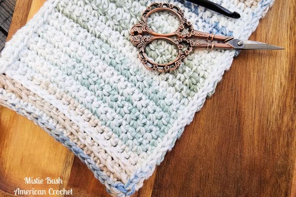 Close-up of the crochet stitches on Levi’s Gentle Stitches burp cloth, showcasing texture and detail.