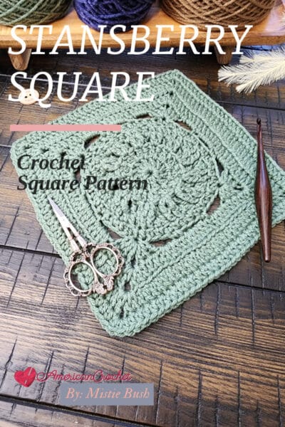 Stansberry Square crochet block styled with a wooden crochet hook and ornate scissors, showcasing the stitch textures against a warm wooden background