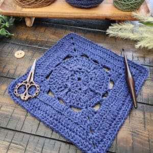 Acquaintance Square crochet pattern – a 9-inch afghan block featuring single crochet, half double, double, treble crochet stitches, and back loop only rows. Part of the Riverwood Square CAL 2025 hosted by American Crochet.