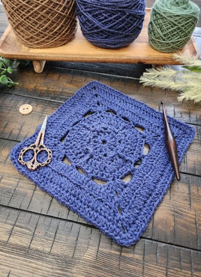 Acquaintance Square crochet pattern – a 9-inch afghan block featuring single crochet, half double, double, treble crochet stitches, and back loop only rows. Part of the Riverwood Square CAL 2025 hosted by American Crochet.