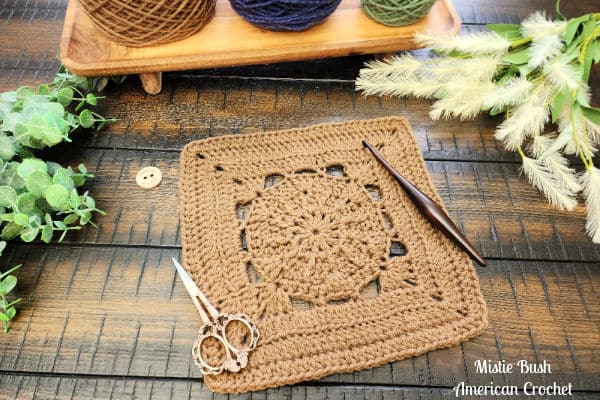 Hype Square crochet block laid flat on a wooden background, showing clean rows of extended single crochet, FPdc, and BLO stitches.